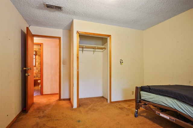 3412 Tin Top Rd, Weatherford, TX 76087 - carpeted bedroom featuring a textured ceiling, a closet, and baseboards