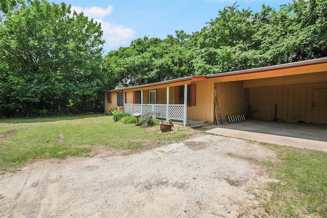 3412 Tin Top Rd, Weatherford, TX 76087 - view of front of house featuring driveway, a front lawn, an attached carport, and covered porch