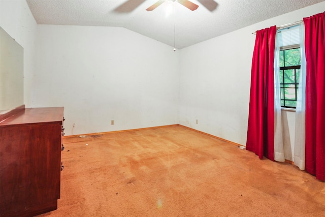 3412 Tin Top Rd, Weatherford, TX 76087 - spare room featuring ceiling fan, carpet, lofted ceiling, a textured ceiling, and baseboards