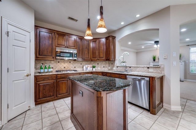 4465 Mira Vista Dr, Frisco, TX 75034 - kitchen featuring stainless steel appliances, a ceiling fan, arched walkways, backsplash, and light tile patterned flooring