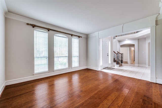 4465 Mira Vista Dr, Frisco, TX 75034 - unfurnished room featuring arched walkways, light wood-type flooring, baseboards, stairway, and ornamental molding