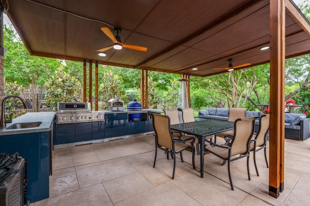 view of patio with a ceiling fan, outdoor lounge area, exterior kitchen, and a sink