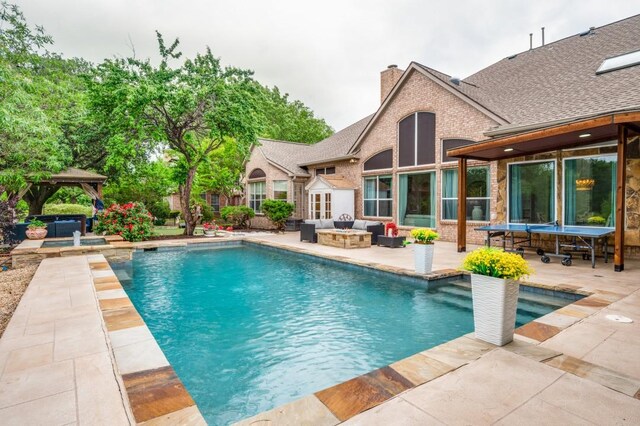 pool featuring a gazebo, a patio area, and an outdoor hangout area