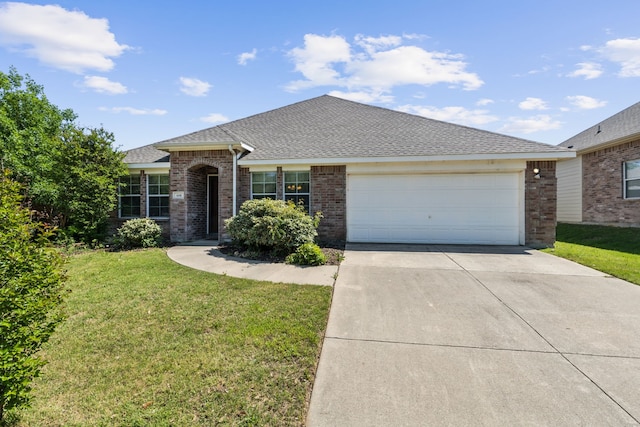 single story home featuring a front yard, a shingled roof, brick siding, concrete driveway, and an attached garage