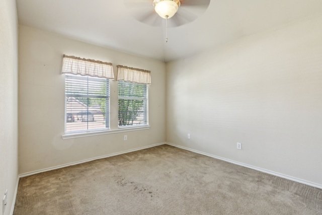 spare room with baseboards, a ceiling fan, and carpet flooring