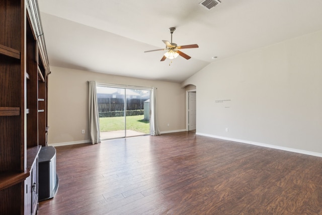 unfurnished living room with dark wood finished floors, visible vents, a ceiling fan, and lofted ceiling