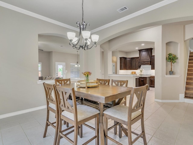 dining space with visible vents, baseboards, ornamental molding, stairs, and light tile patterned flooring
