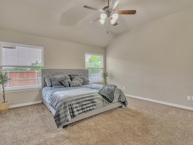 bedroom with vaulted ceiling, baseboards, ceiling fan, and carpet flooring