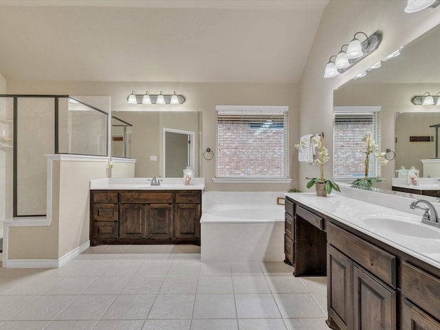 bathroom featuring tile patterned flooring, a garden tub, two vanities, a sink, and a stall shower
