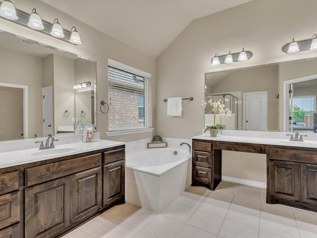 bathroom featuring a garden tub, a sink, two vanities, and vaulted ceiling