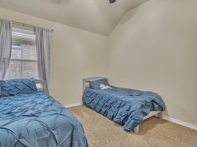 bedroom featuring carpet floors, baseboards, ceiling fan, and vaulted ceiling