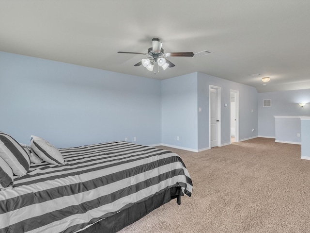 carpeted bedroom with visible vents, a ceiling fan, and baseboards