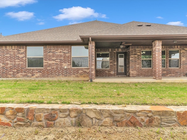 back of property with a ceiling fan, a shingled roof, a patio area, and brick siding