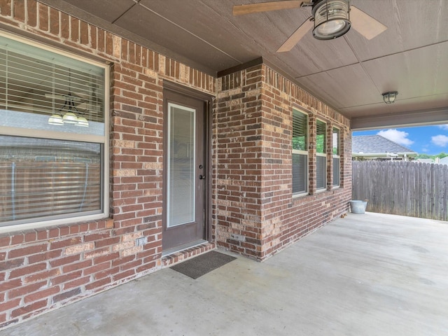 view of patio featuring ceiling fan and fence