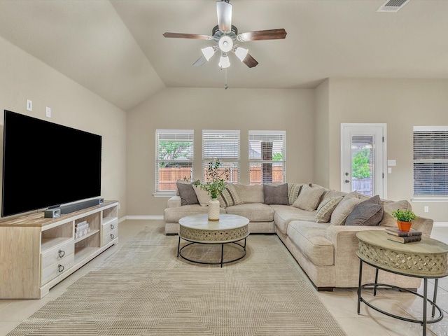 living area with visible vents, light tile patterned flooring, baseboards, ceiling fan, and vaulted ceiling