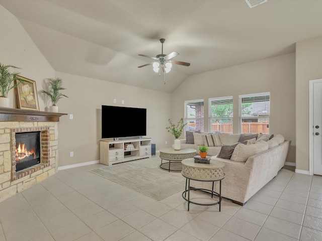 living room featuring ceiling fan, light tile patterned floors, vaulted ceiling, and a fireplace
