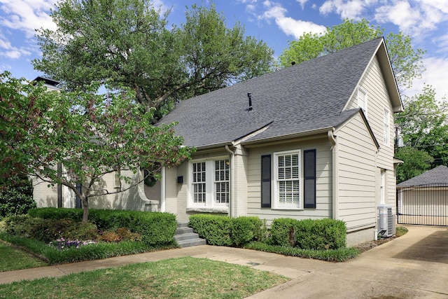 4108 Greenbrier Dr, University Park, TX 75225 - view of front of property featuring a shingled roof, an outbuilding, and central AC unit