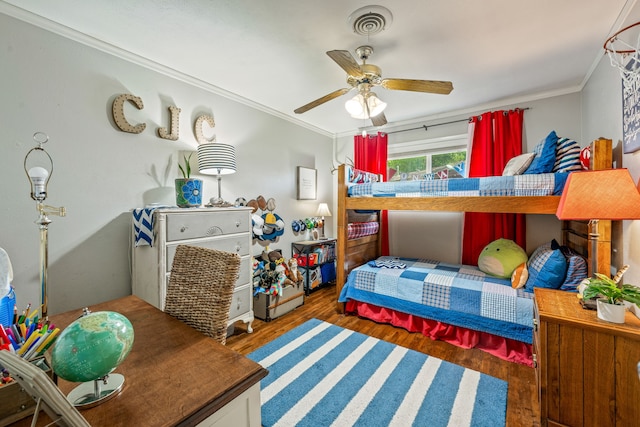 bedroom with ceiling fan, ornamental molding, and wood finished floors