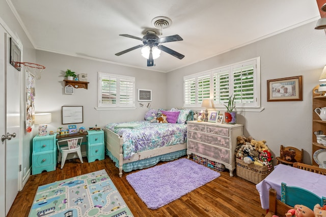 bedroom featuring crown molding, ceiling fan, wood finished floors, and multiple windows