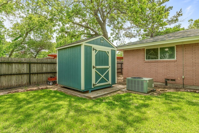 view of shed with a fenced backyard and central AC unit