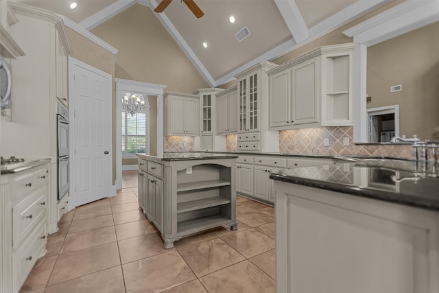 kitchen with dark countertops, open shelves, and backsplash