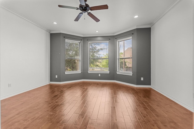 spare room featuring ceiling fan, ornamental molding, baseboards, and hardwood / wood-style floors
