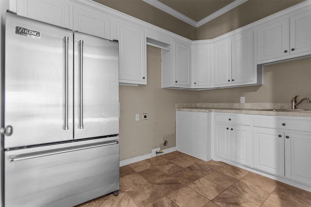 clothes washing area with crown molding, laundry area, baseboards, electric dryer hookup, and a sink