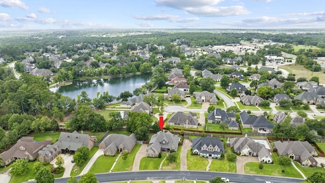 drone / aerial view featuring a residential view and a water view
