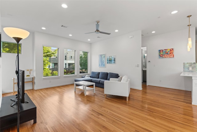 living room featuring recessed lighting, ceiling fan, light wood-style floors, and visible vents
