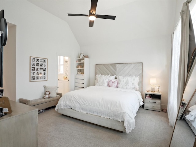 carpeted bedroom with a ceiling fan, vaulted ceiling, and ensuite bath