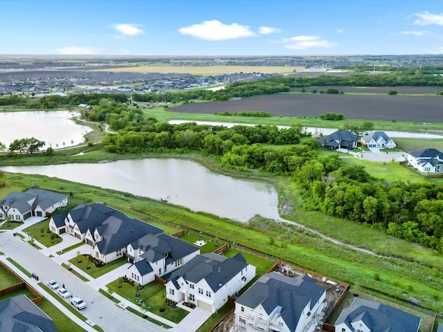 drone / aerial view with a water view and a residential view