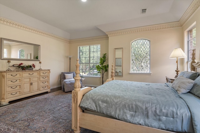 bedroom featuring baseboards, visible vents, and ornamental molding