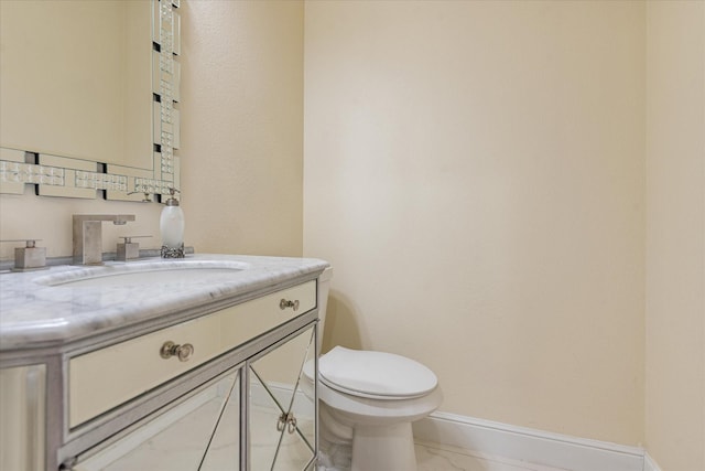 half bath with baseboards, toilet, vanity, and marble finish floor