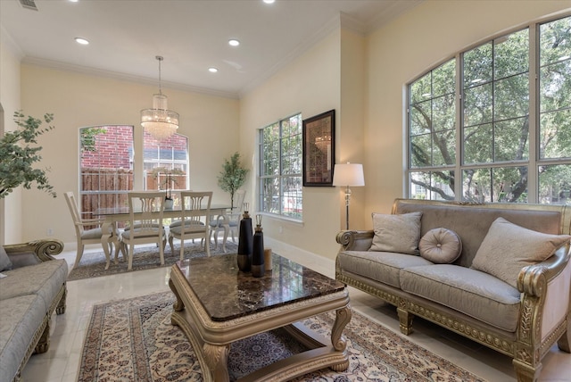 living area with ornamental molding, recessed lighting, a notable chandelier, and baseboards