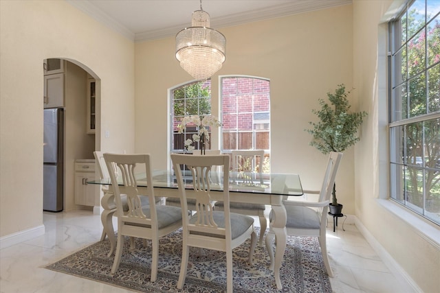 dining area with crown molding, baseboards, arched walkways, a notable chandelier, and marble finish floor