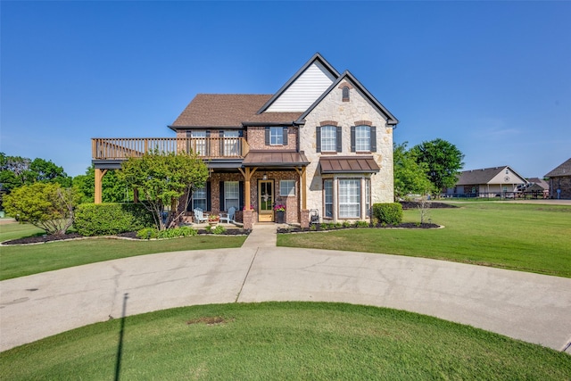 122 Forest Hills Cir, Gunter, TX 75058 - view of front of house with covered porch, a standing seam roof, brick siding, a balcony, and a front yard