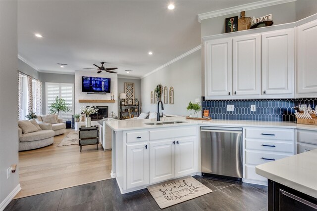 122 Forest Hills Cir, Gunter, TX 75058 - kitchen with stainless steel dishwasher, a sink, light countertops, ornamental molding, and a peninsula