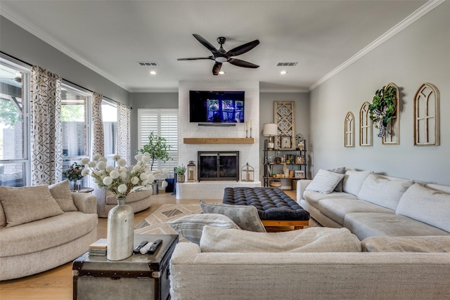 122 Forest Hills Cir, Gunter, TX 75058 - living room featuring a fireplace, wood finished floors, ceiling fan, and visible vents