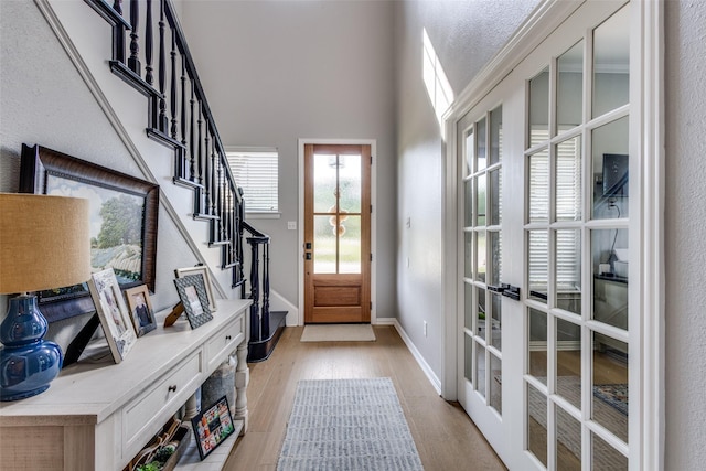 122 Forest Hills Cir, Gunter, TX 75058 - doorway with baseboards, stairway, french doors, and light wood finished floors