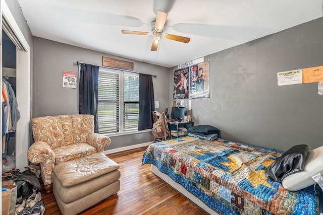 bedroom featuring baseboards, ceiling fan, and hardwood / wood-style flooring