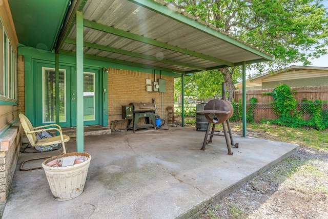 view of patio with fence, area for grilling, and french doors