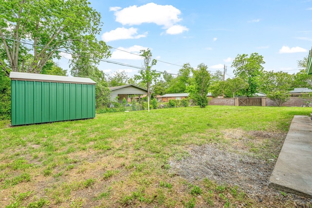 view of yard featuring fence and an outdoor structure