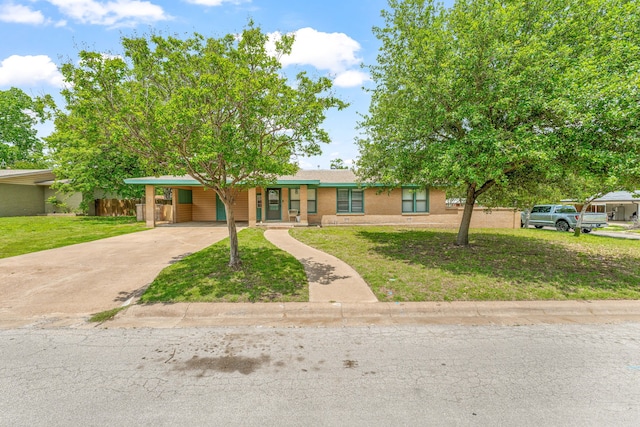 view of front of house featuring an attached carport, driveway, and a front lawn
