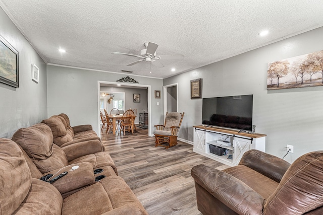 living room with recessed lighting, a textured ceiling, light wood finished floors, and ceiling fan