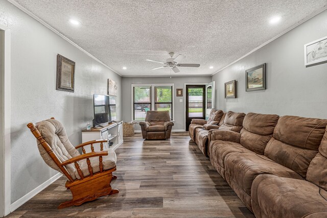 living room with crown molding, a textured ceiling, a ceiling fan, recessed lighting, and wood finished floors
