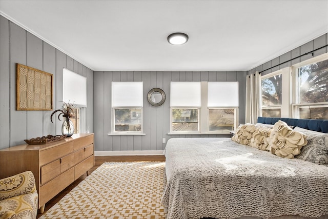 bedroom with wood finished floors and baseboards