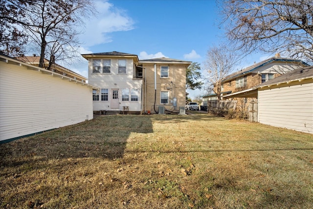 rear view of property with a lawn