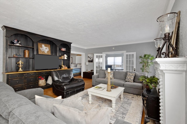 living room with ornamental molding, a textured ceiling, and wood finished floors