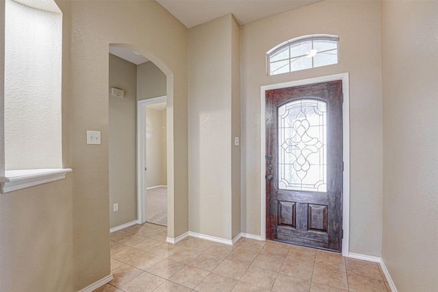 1108 Mourning Dove Dr, Burleson, TX 76028 - entryway with light tile patterned floors, arched walkways, and baseboards