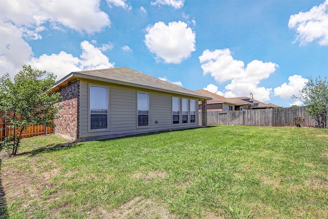 1108 Mourning Dove Dr, Burleson, TX 76028 - rear view of house with brick siding, a fenced backyard, and a lawn